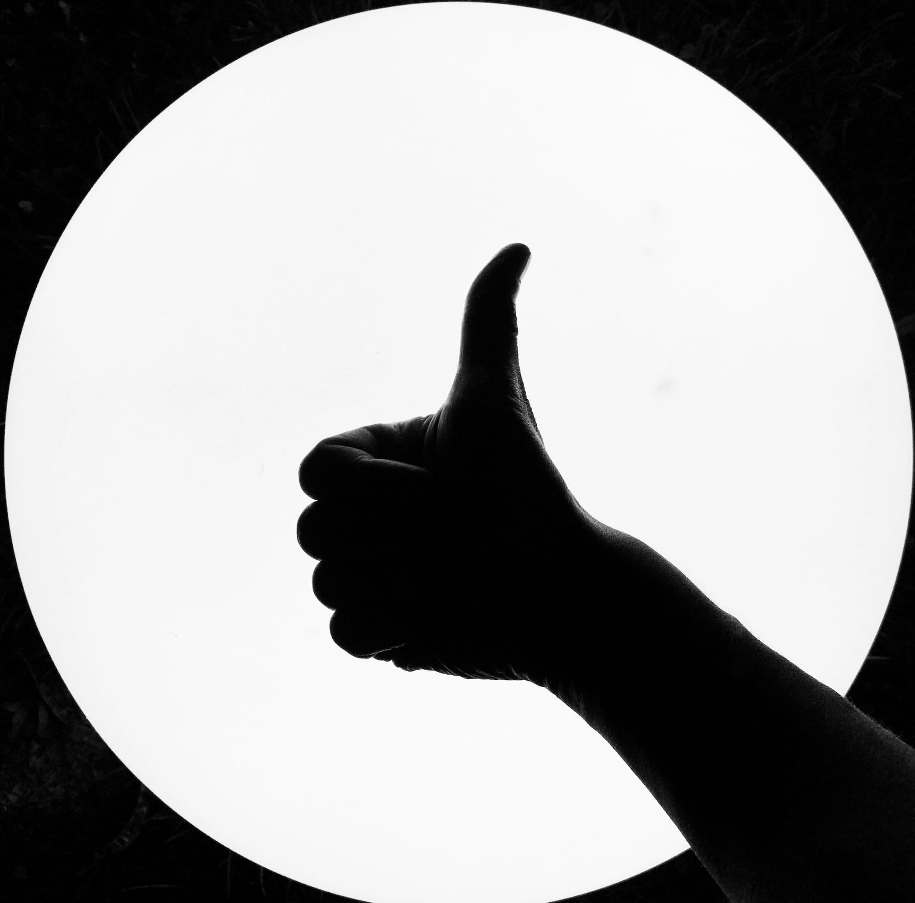 persons hand on white round board