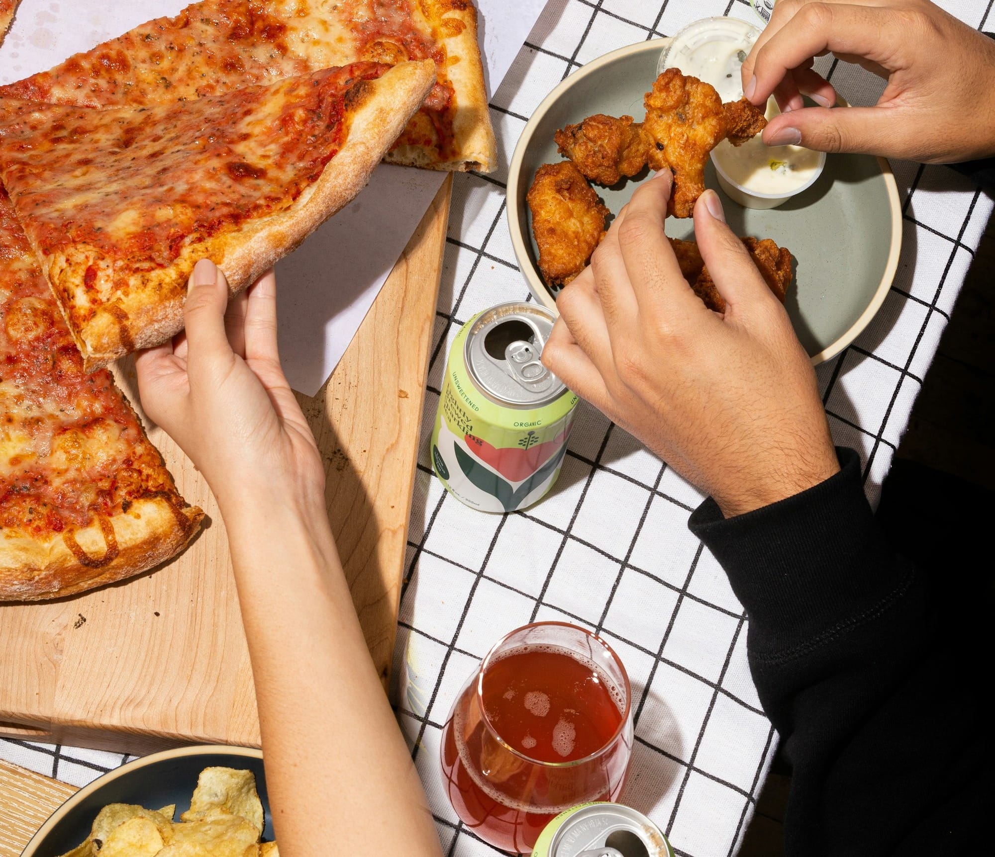 person holding sliced pizza on white ceramic plate